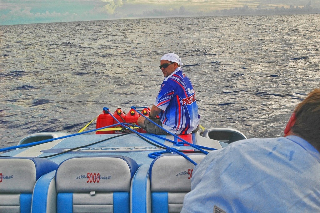 Kevin Cooper checks on ’Team Predator’s fuel reserves, jerry cans lashed aft which threatened to come adrift as heavy seas pounded the boat.   - Key West to Cancun world record © Jay Nichols